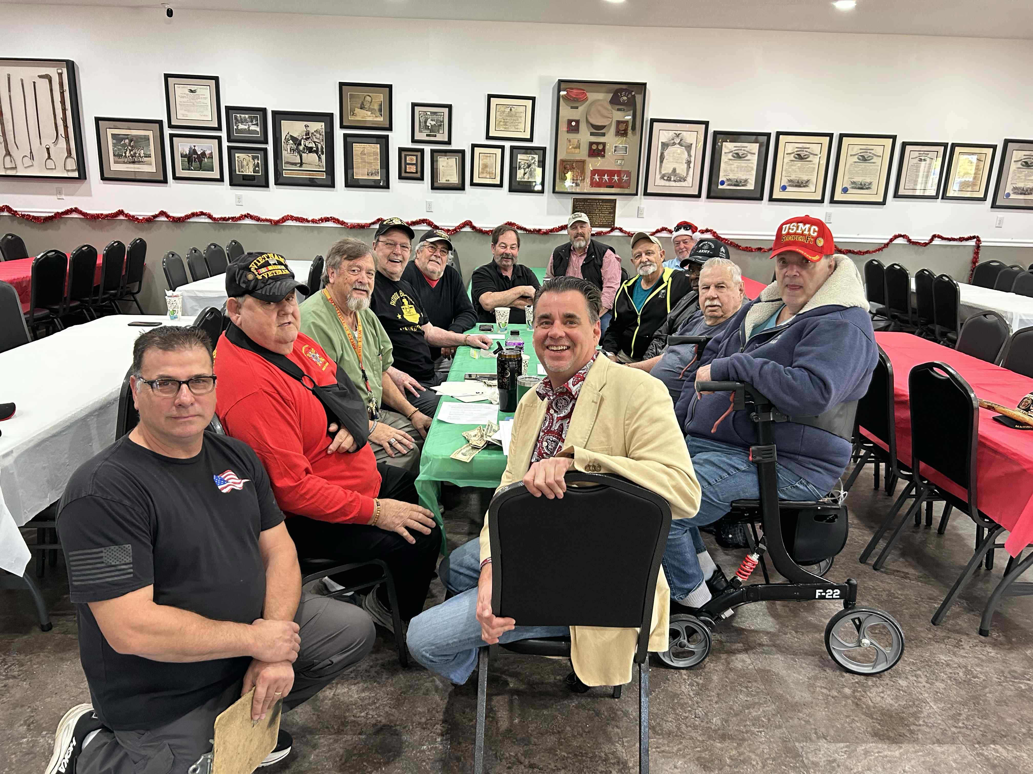 The Veterans PTSD group at the Wainwright VFW in Panama City, Florida — the men who received the very first Maddie's Warriors bracelets, with George Fountain seated in the red shirt.